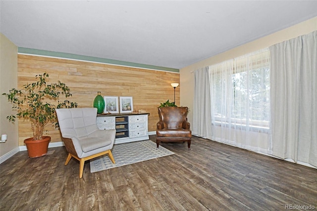 1673 Woodmoor Dr, Monument, CO 80132 - living area featuring wooden walls, wood finished floors, and baseboards