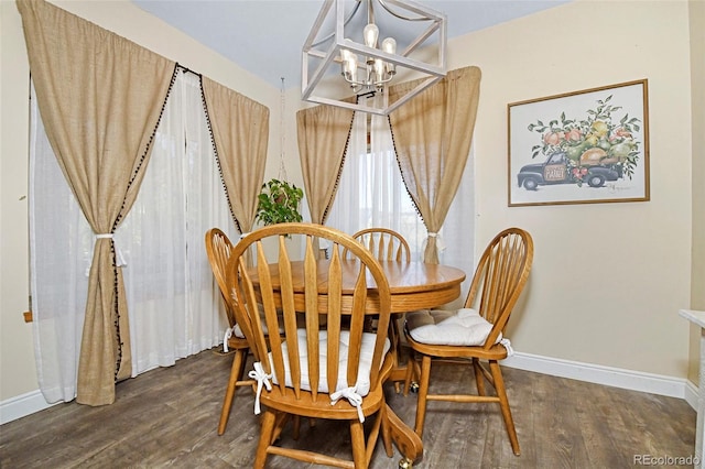 1673 Woodmoor Dr, Monument, CO 80132 - dining room featuring a chandelier, wood finished floors, and baseboards