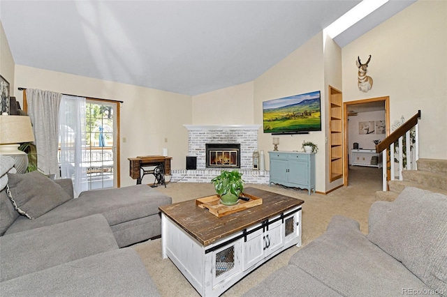 1673 Woodmoor Dr, Monument, CO 80132 - living room with light carpet, vaulted ceiling, a fireplace, and stairs
