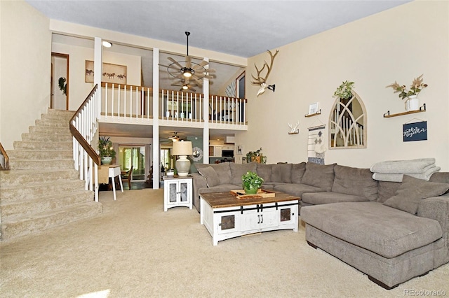 1673 Woodmoor Dr, Monument, CO 80132 - living room with carpet, a ceiling fan, stairway, and a high ceiling