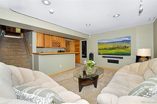 1673 Woodmoor Dr, Monument, CO 80132 - carpeted living room with bar with sink, baseboards, stairs, and recessed lighting
