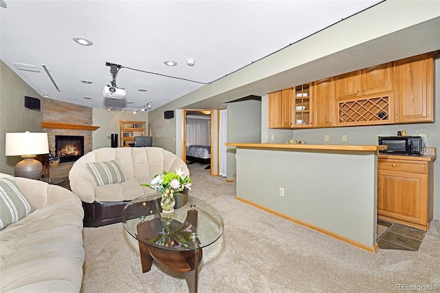 1673 Woodmoor Dr, Monument, CO 80132 - living area with light colored carpet, bar with sink, a large fireplace, recessed lighting, and baseboards