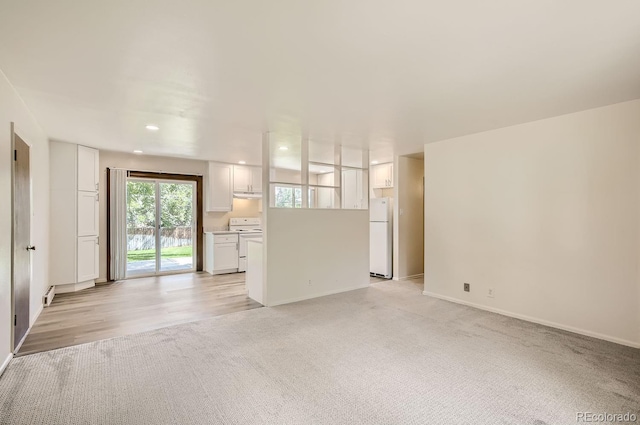 3205 Moorhead Ave, Boulder, CO 80305 - unfurnished living room with light carpet, baseboards, and recessed lighting