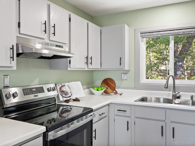 11650 Baca Rd, Conifer, CO 80433 - kitchen with electric range, under cabinet range hood, a sink, light countertops, and white cabinets