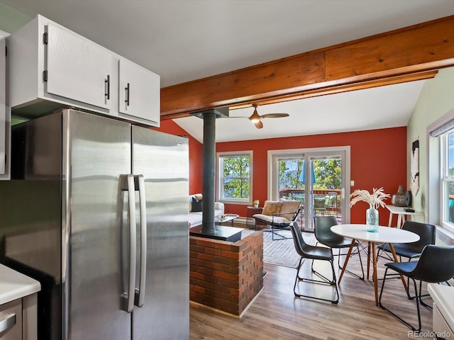 11650 Baca Rd, Conifer, CO 80433 - kitchen with freestanding refrigerator, beam ceiling, light wood-style flooring, white cabinets, and ornate columns