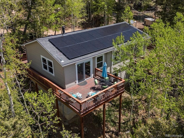 11650 Baca Rd, Conifer, CO 80433 - back of property featuring roof mounted solar panels, a deck, and roof with shingles