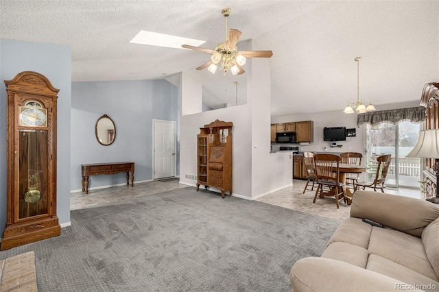 living area with light carpet, high vaulted ceiling, ceiling fan with notable chandelier, a textured ceiling, and baseboards