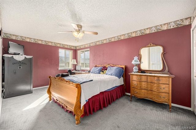 carpeted bedroom with a ceiling fan, baseboards, and a textured ceiling