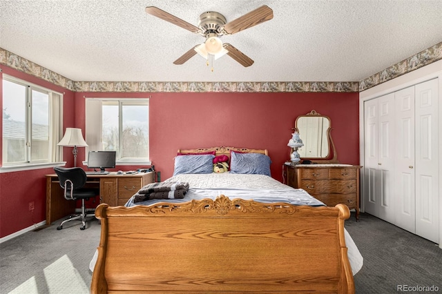 carpeted bedroom with a closet, baseboards, a textured ceiling, and ceiling fan