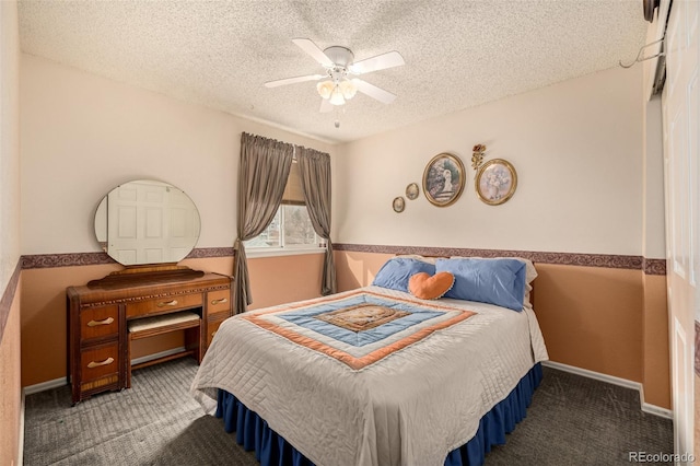 bedroom with a wainscoted wall, a textured ceiling, ceiling fan, and carpet flooring