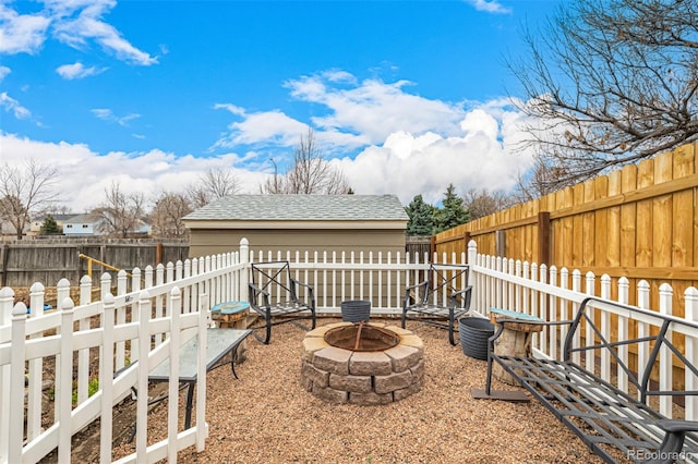 view of yard with a fire pit and a fenced backyard