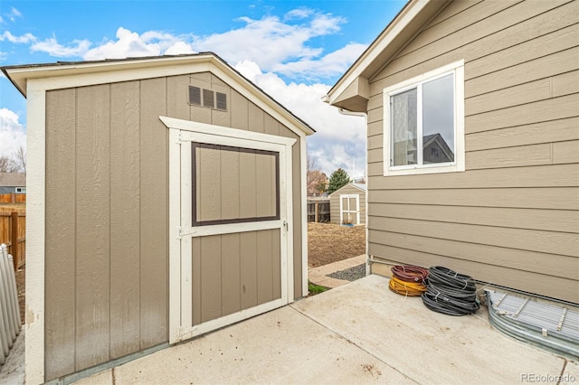 view of shed with fence