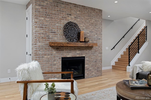 living room featuring a fireplace and light hardwood / wood-style flooring