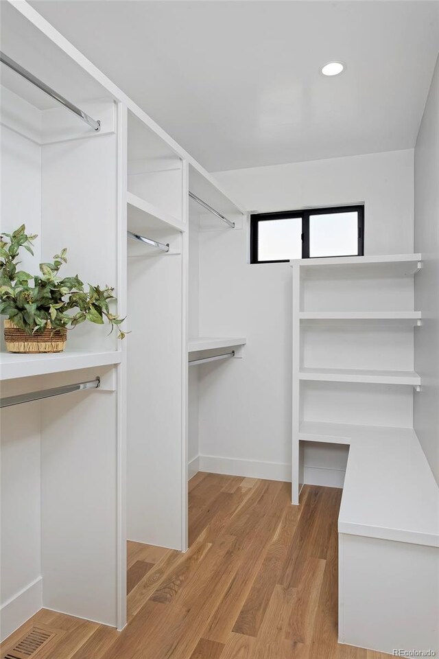 spacious closet with light hardwood / wood-style floors