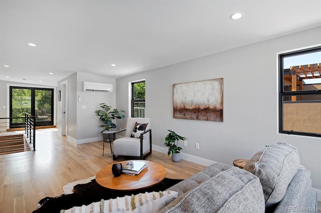 living room featuring light hardwood / wood-style floors and a wall mounted AC