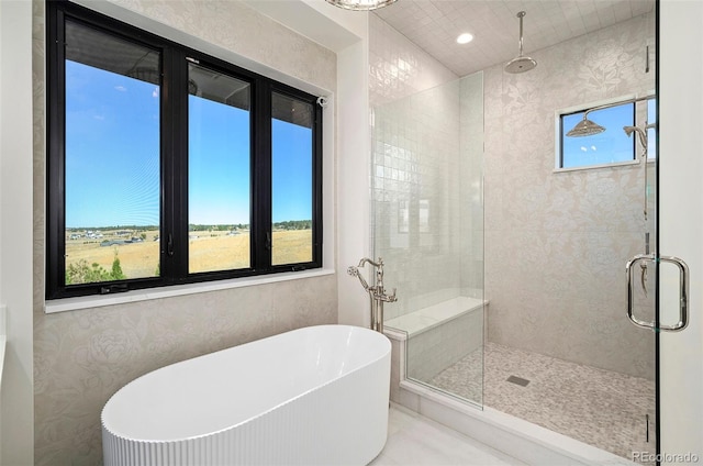 bathroom with independent shower and bath and plenty of natural light