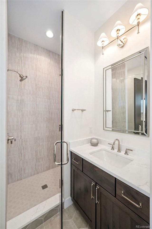 bathroom with vanity, a shower with shower door, and tile patterned flooring