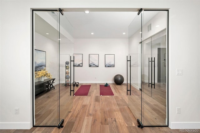 workout area with wood-type flooring