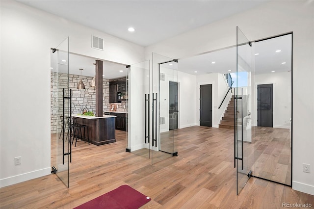 interior space with light hardwood / wood-style flooring and indoor bar