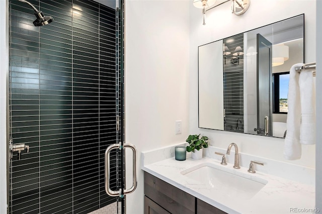 bathroom with vanity and a shower with shower door