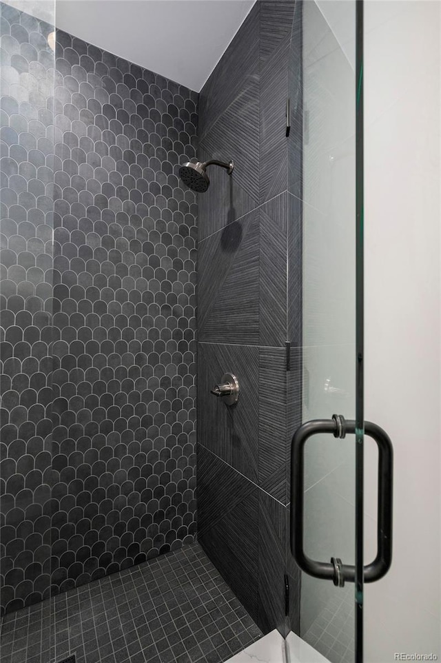 bathroom with a shower with door