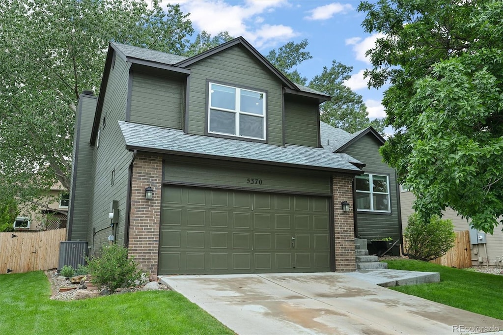 5370 S Union Way, Littleton, CO 80127 - view of front of house featuring a garage, brick siding, concrete driveway, a chimney, and central AC