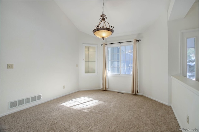 spare room featuring vaulted ceiling and carpet floors