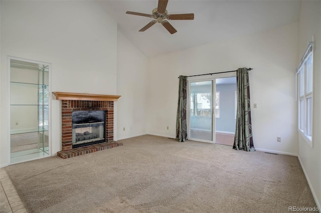 unfurnished living room featuring light carpet, a fireplace, high vaulted ceiling, and ceiling fan