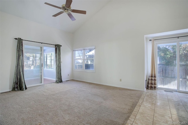 empty room featuring ceiling fan, light colored carpet, and high vaulted ceiling