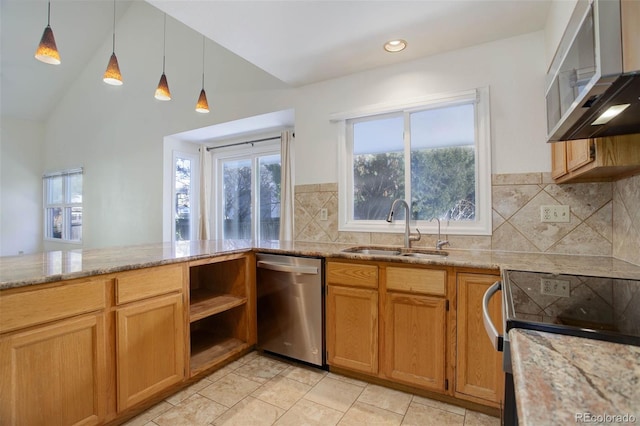 kitchen featuring stainless steel appliances, hanging light fixtures, sink, and light stone counters