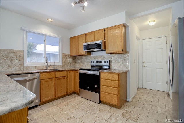 kitchen featuring light tile patterned floors, stainless steel appliances, sink, and backsplash