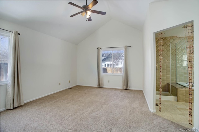 unfurnished bedroom with ceiling fan, lofted ceiling, light colored carpet, and ensuite bath