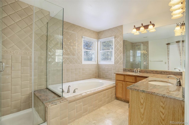 bathroom featuring independent shower and bath, vanity, and tile patterned floors