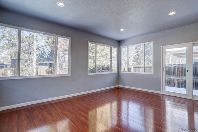 empty room featuring hardwood / wood-style floors and a textured ceiling