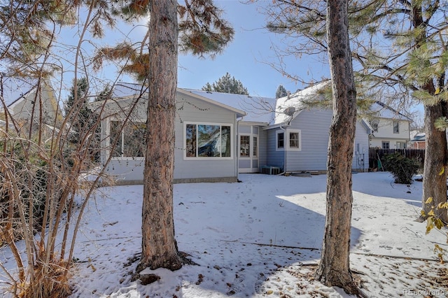 view of snow covered rear of property