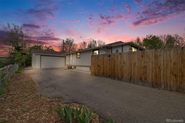 3015 Pierce St, Wheat Ridge, CO 80214 - view of front facade with driveway, an attached garage, and stucco siding
