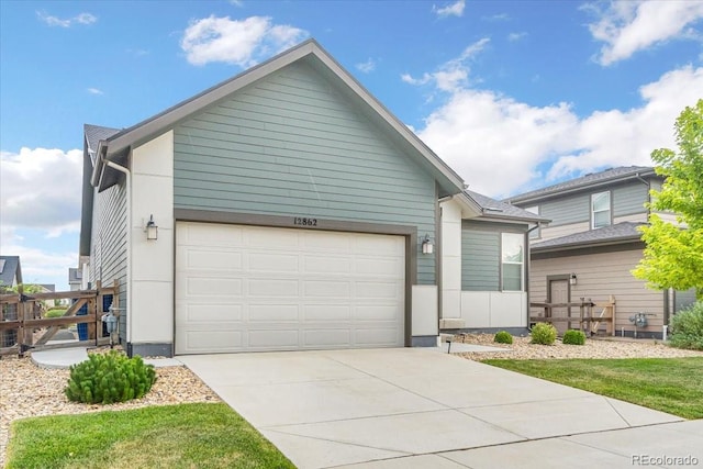 12862 Crane River Dr, Longmont, CO 80504 - view of front facade featuring driveway and a garage
