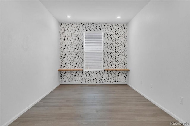 12862 Crane River Dr, Longmont, CO 80504 - spare room with wood finished floors and recessed lighting