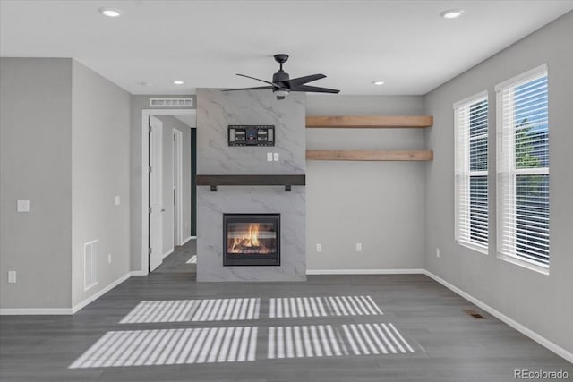 12862 Crane River Dr, Longmont, CO 80504 - unfurnished living room with wood finished floors, a high end fireplace, recessed lighting, and ceiling fan