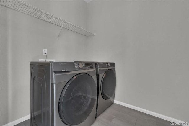 12862 Crane River Dr, Longmont, CO 80504 - laundry room with washer and dryer and wood finished floors
