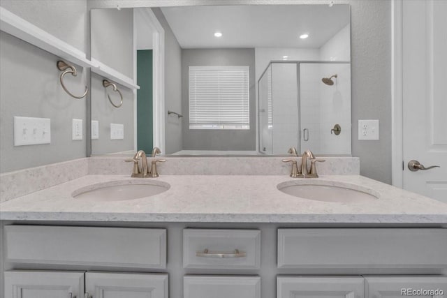 12862 Crane River Dr, Longmont, CO 80504 - full bathroom featuring double vanity, a shower stall, and recessed lighting