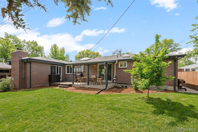 5455 E Iowa Ave, Denver, CO 80222 - back of house with brick siding, a patio, and a chimney