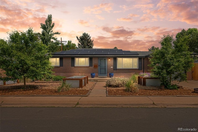 5455 E Iowa Ave, Denver, CO 80222 - ranch-style home with brick siding and solar panels
