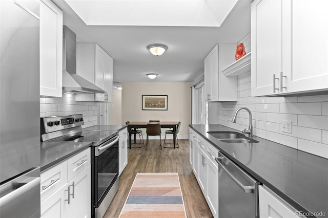 5455 E Iowa Ave, Denver, CO 80222 - kitchen with appliances with stainless steel finishes, a sink, wall chimney range hood, and dark countertops