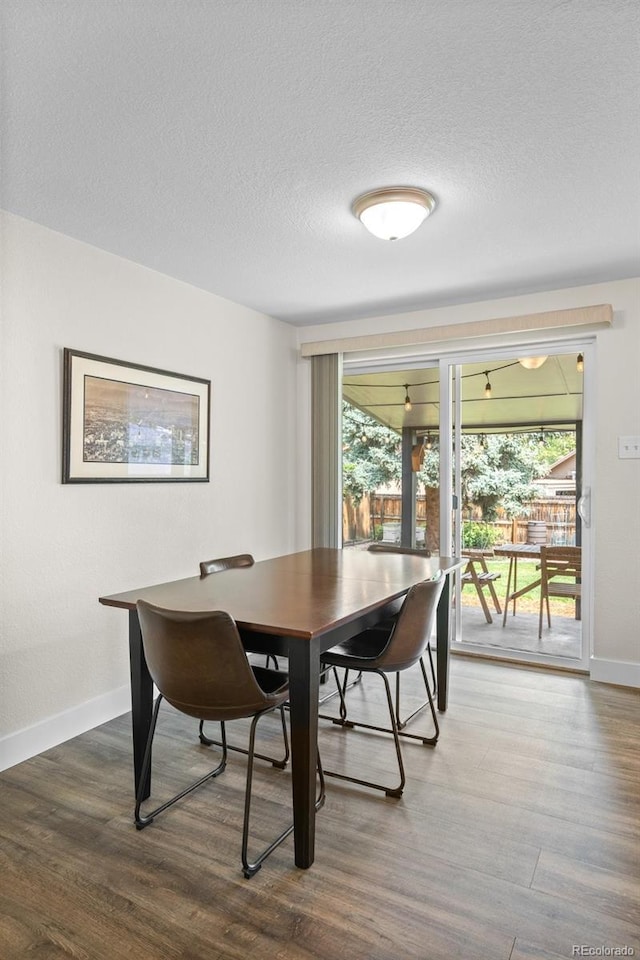 5455 E Iowa Ave, Denver, CO 80222 - dining room with wood finished floors, healthy amount of natural light, baseboards, and a textured ceiling