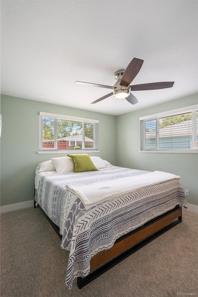 5455 E Iowa Ave, Denver, CO 80222 - carpeted bedroom with multiple windows, baseboards, and a ceiling fan