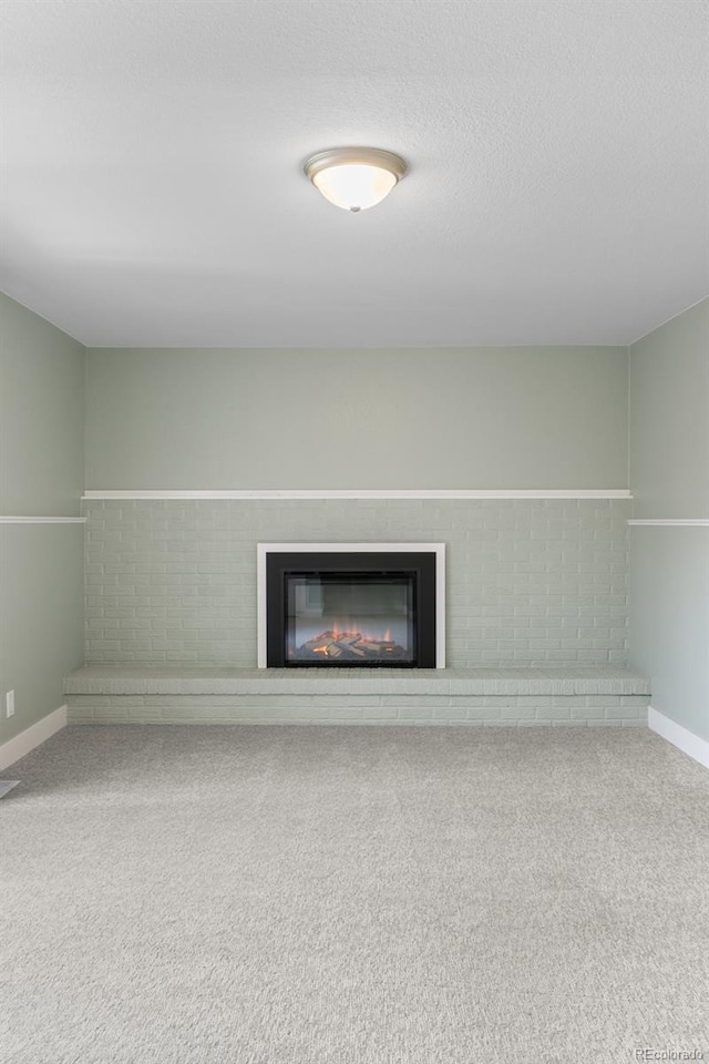 5455 E Iowa Ave, Denver, CO 80222 - detailed view of a glass covered fireplace, carpet flooring, and baseboards
