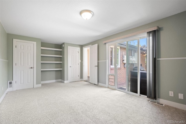 5455 E Iowa Ave, Denver, CO 80222 - unfurnished bedroom featuring access to outside, carpet, and baseboards