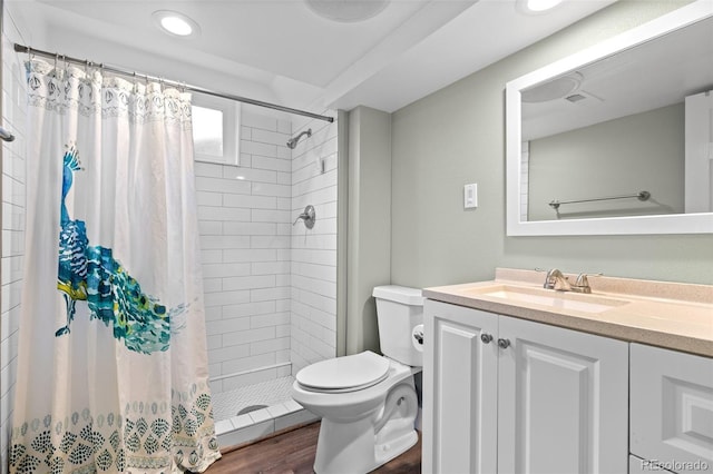 5455 E Iowa Ave, Denver, CO 80222 - full bath with toilet, vanity, recessed lighting, a tile shower, and wood finished floors