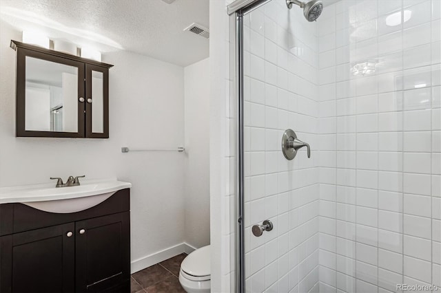 bathroom featuring walk in shower, tile patterned floors, a textured ceiling, toilet, and vanity